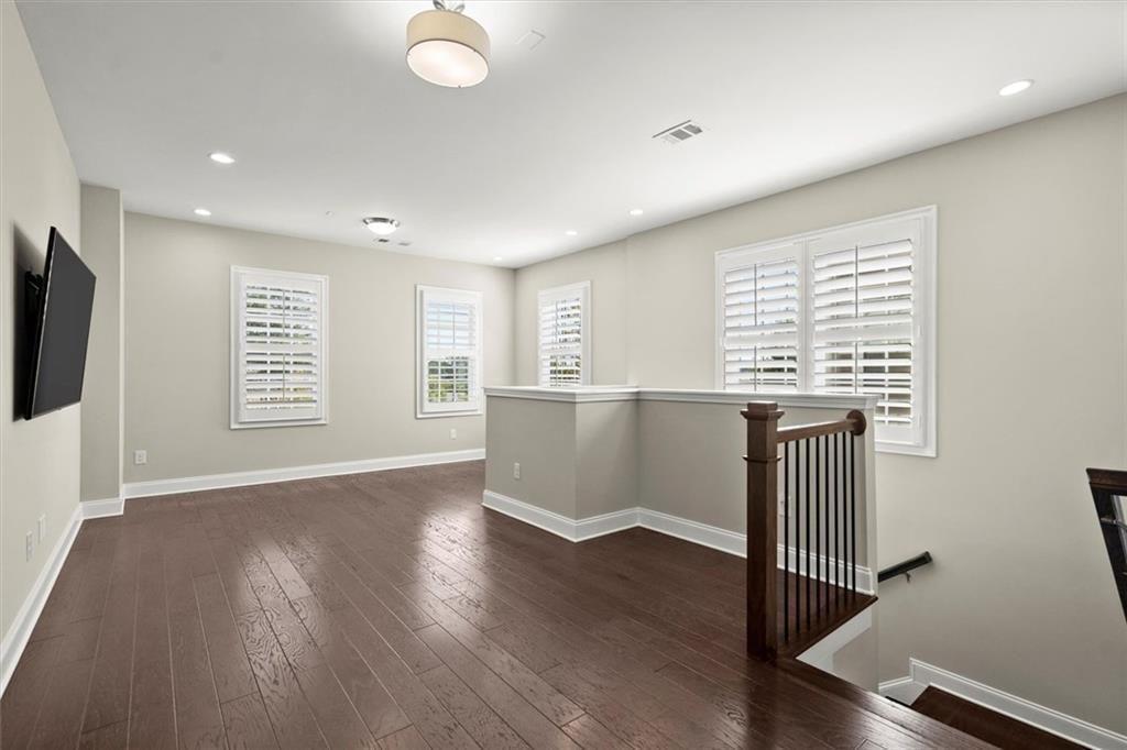 293 Thompson Street Alpharetta, GA 30009 - Photo 30 of 71 a view of an empty room with wooden floor and a window