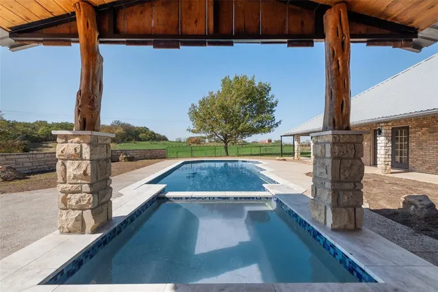 a view of outdoor space with swimming pool and patio