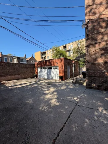 a view of a street with a car parked beside it