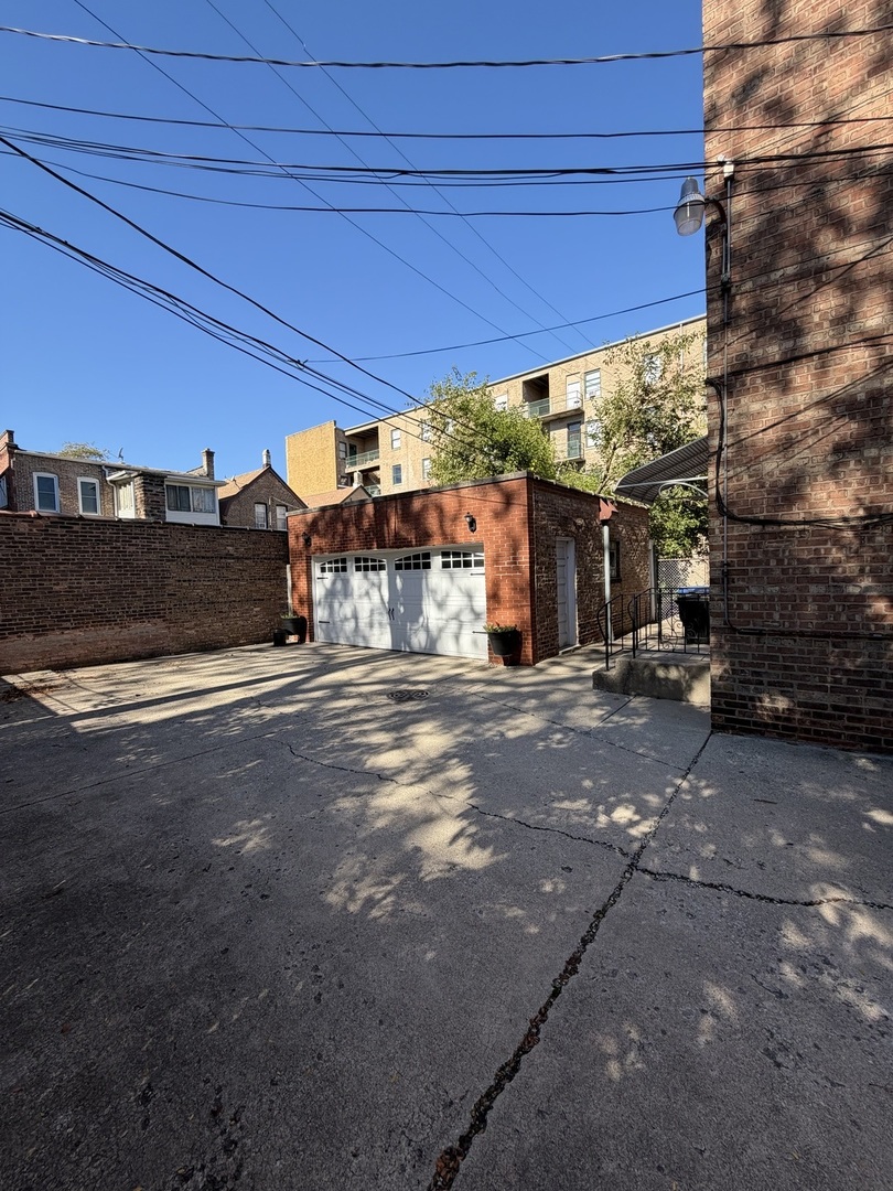 7228 South Phillips Avenue, Unit G Chicago, IL 60649 - Photo 10 of 10 a view of a street with a car parked beside it
