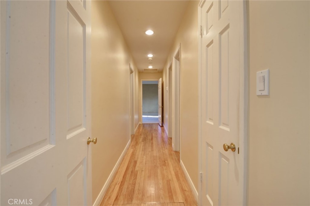 1300 Ramona Road Arcadia, CA 91006 - Photo 26 of 38 a view of a hallway with wooden floor and a bathroom