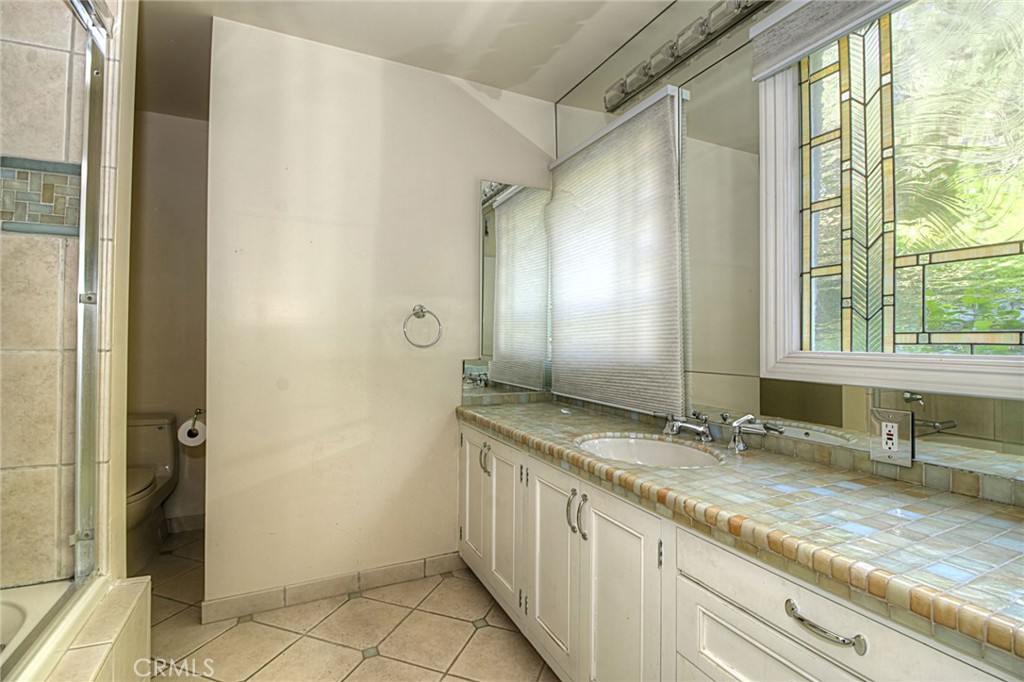 1300 Ramona Road Arcadia, CA 91006 - Photo 33 of 38 a bathroom with a granite countertop sink and a mirror