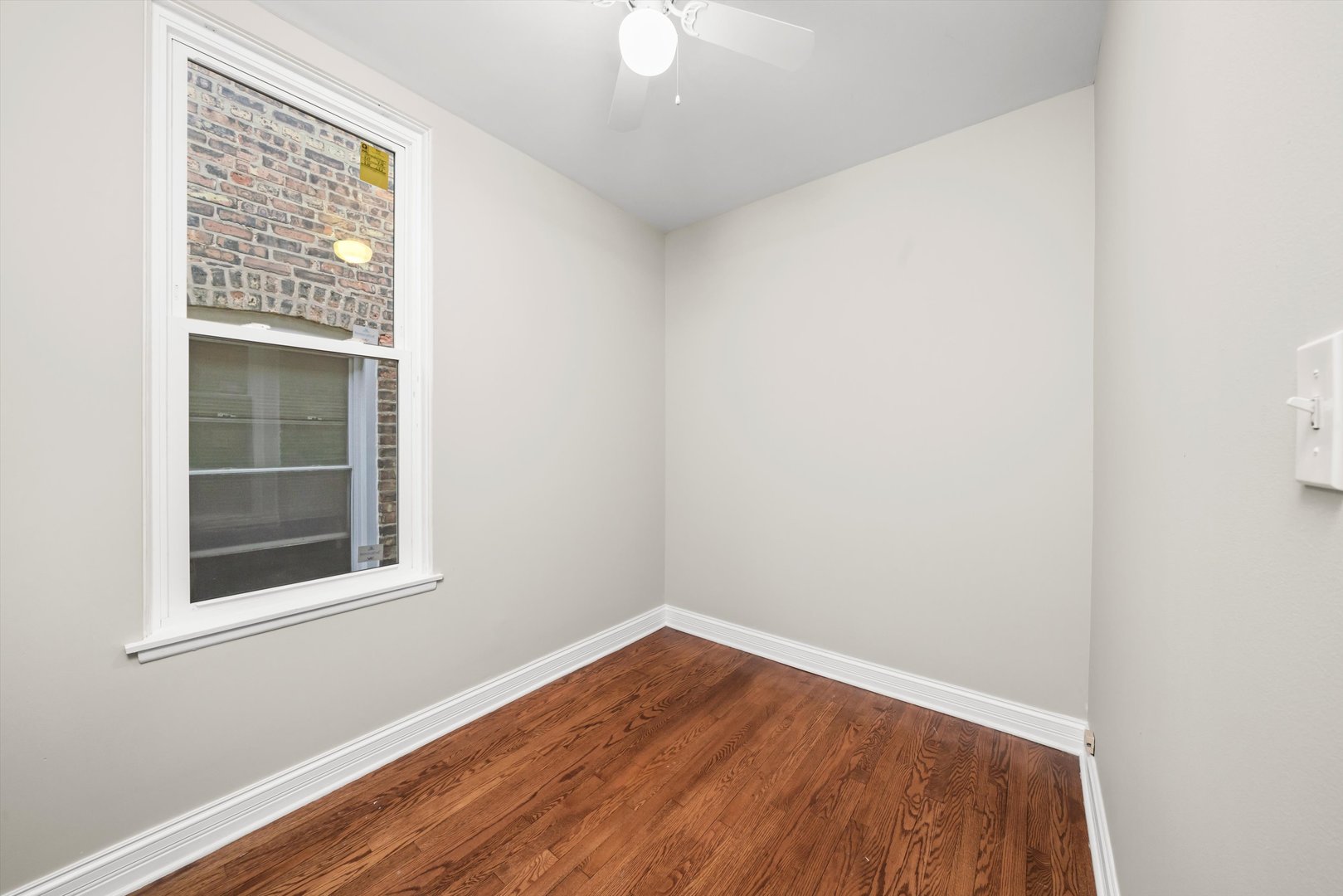 2420 South Oakley Avenue, Unit 2 Chicago, IL 60608 - Photo 11 of 15 a view of empty room with wooden floor and fan