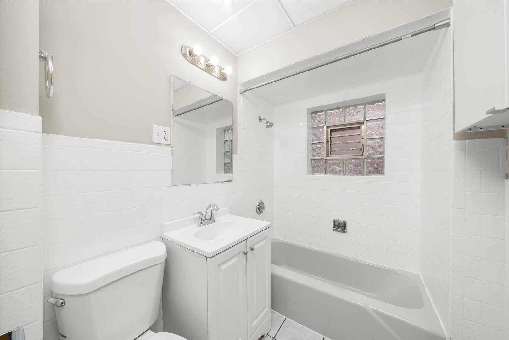 2420 South Oakley Avenue, Unit 2 Chicago, IL 60608 - Photo 13 of 15 a bathroom with a sink a toilet and shower