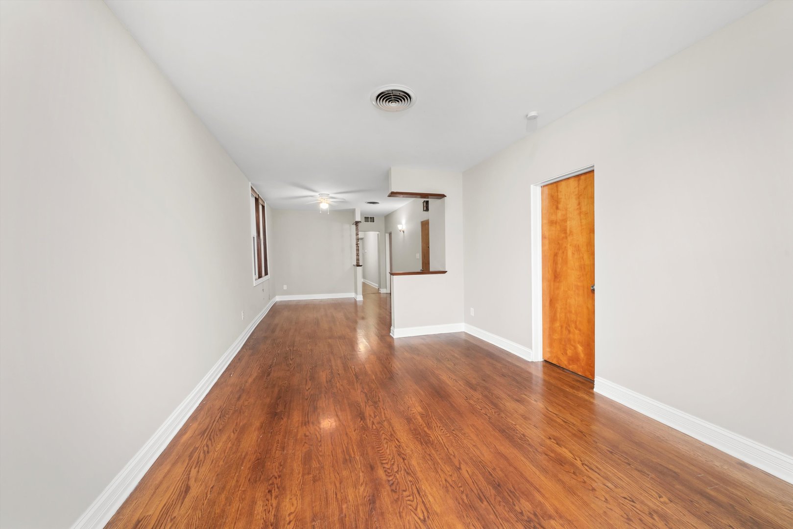 2420 South Oakley Avenue, Unit 2 Chicago, IL 60608 - Photo 2 of 15 a view of a room with wooden floor and a window