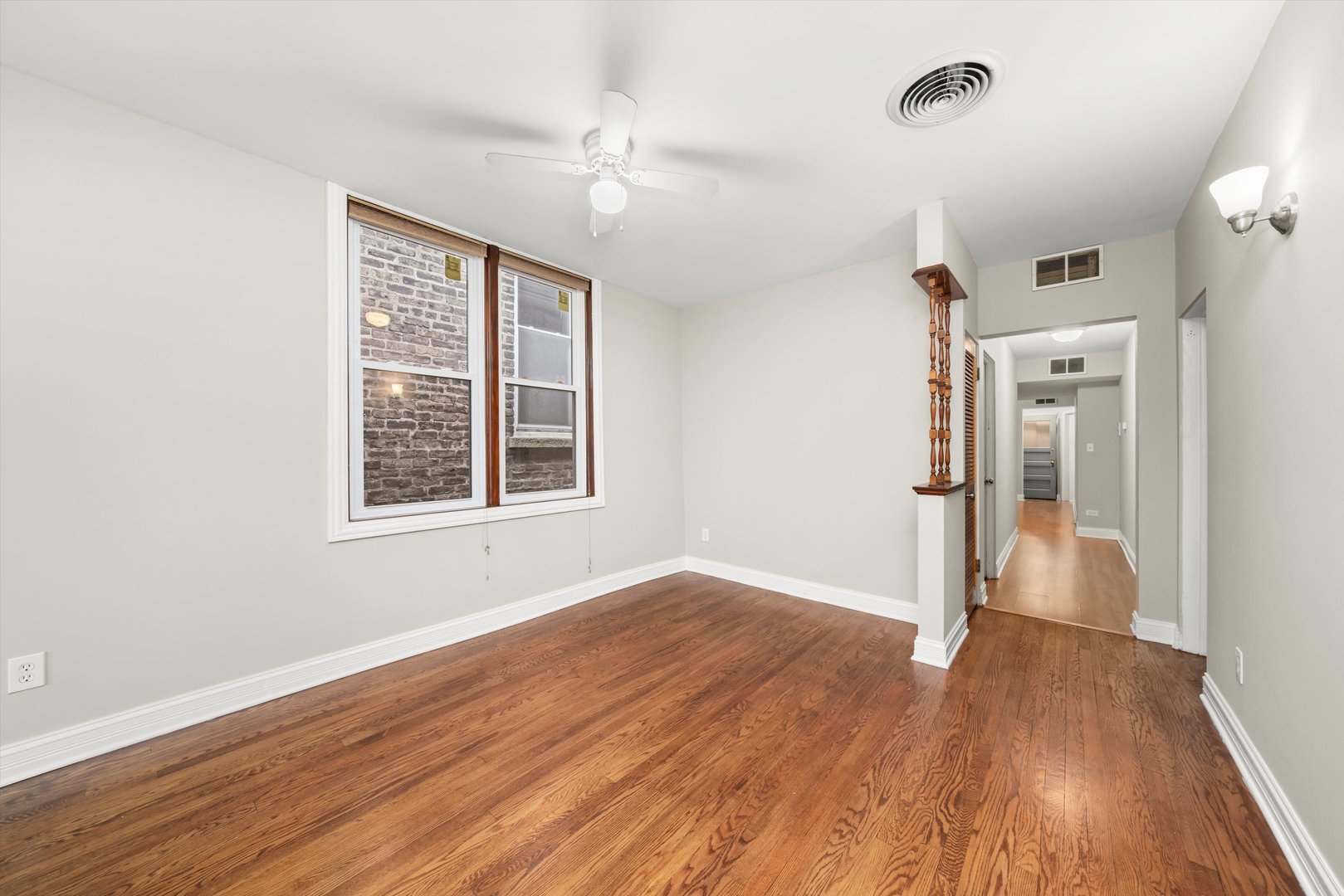 2420 South Oakley Avenue, Unit 2 Chicago, IL 60608 - Photo 3 of 15 a view of empty room with wooden floor and fan