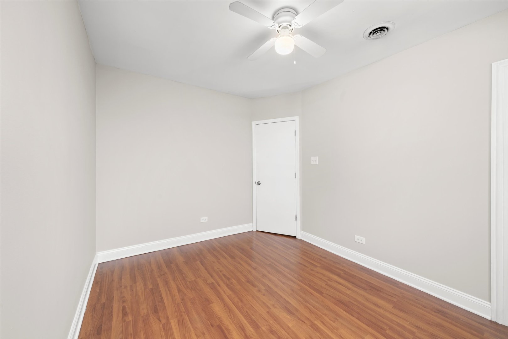 2420 South Oakley Avenue, Unit 2 Chicago, IL 60608 - Photo 6 of 15 an empty room with wooden floor and windows