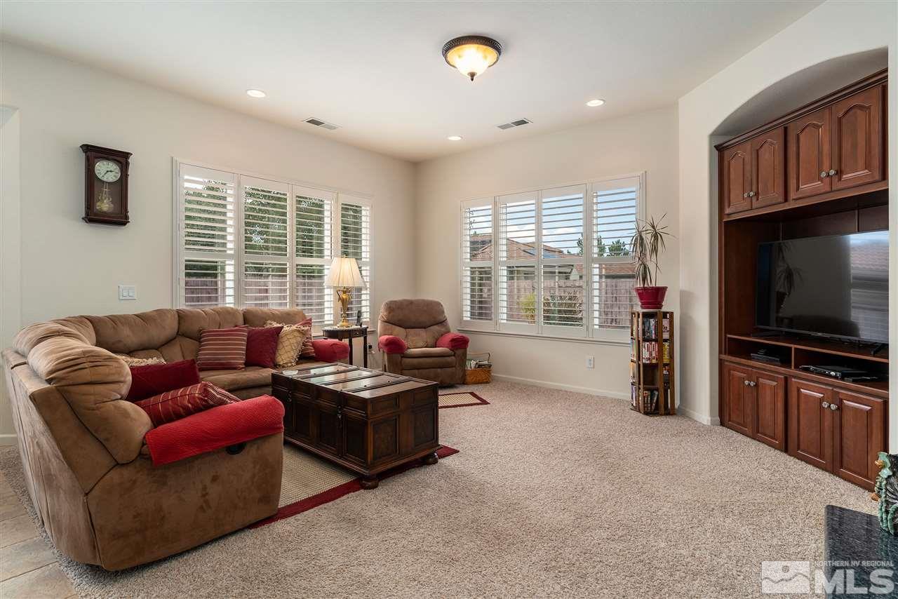 2645 Trail Rider Drive Reno, NV 89521 - Photo 11 of 25 a living room with furniture a flat screen tv and a floor to ceiling window