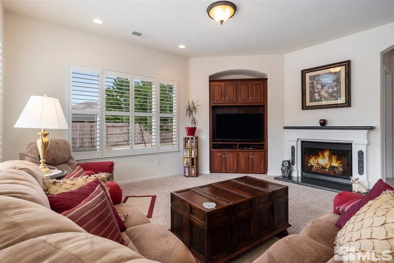2645 Trail Rider Drive Reno, NV 89521 - Photo 12 of 25 a living room with furniture fireplace and a flat screen tv