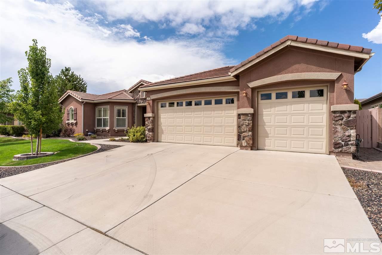2645 Trail Rider Drive Reno, NV 89521 - Photo 2 of 25 a front view of a house with a yard and garage