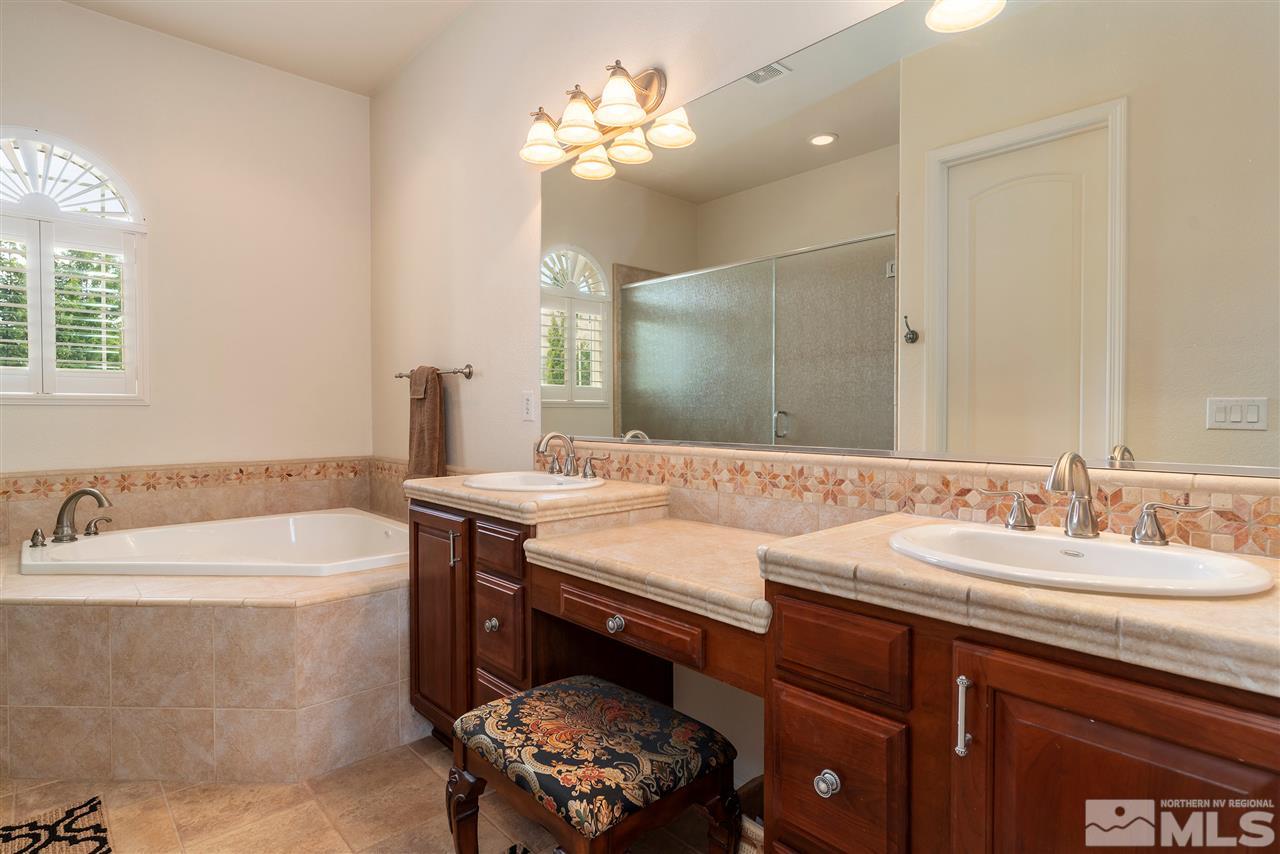 2645 Trail Rider Drive Reno, NV 89521 - Photo 23 of 25 a bathroom with a sink a tub and a mirror