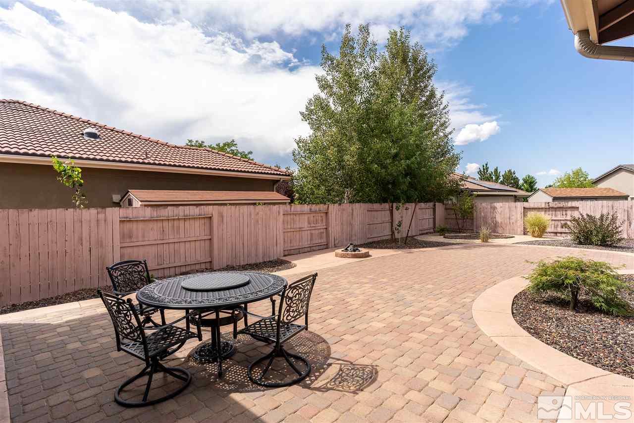2645 Trail Rider Drive Reno, NV 89521 - Photo 3 of 25 a view of a patio with table and chairs with wooden fence