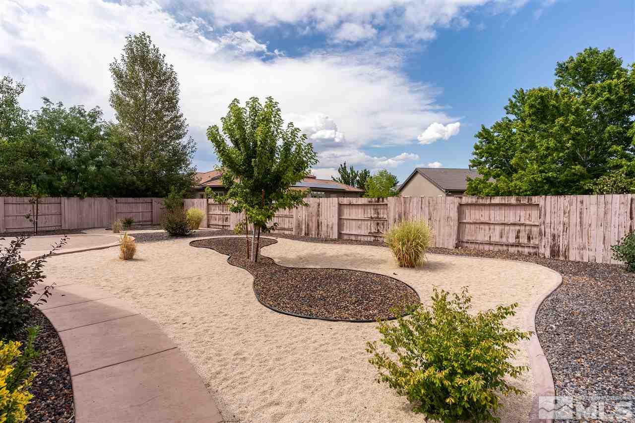 2645 Trail Rider Drive Reno, NV 89521 - Photo 6 of 25 a view of a backyard with large tree and wooden fence