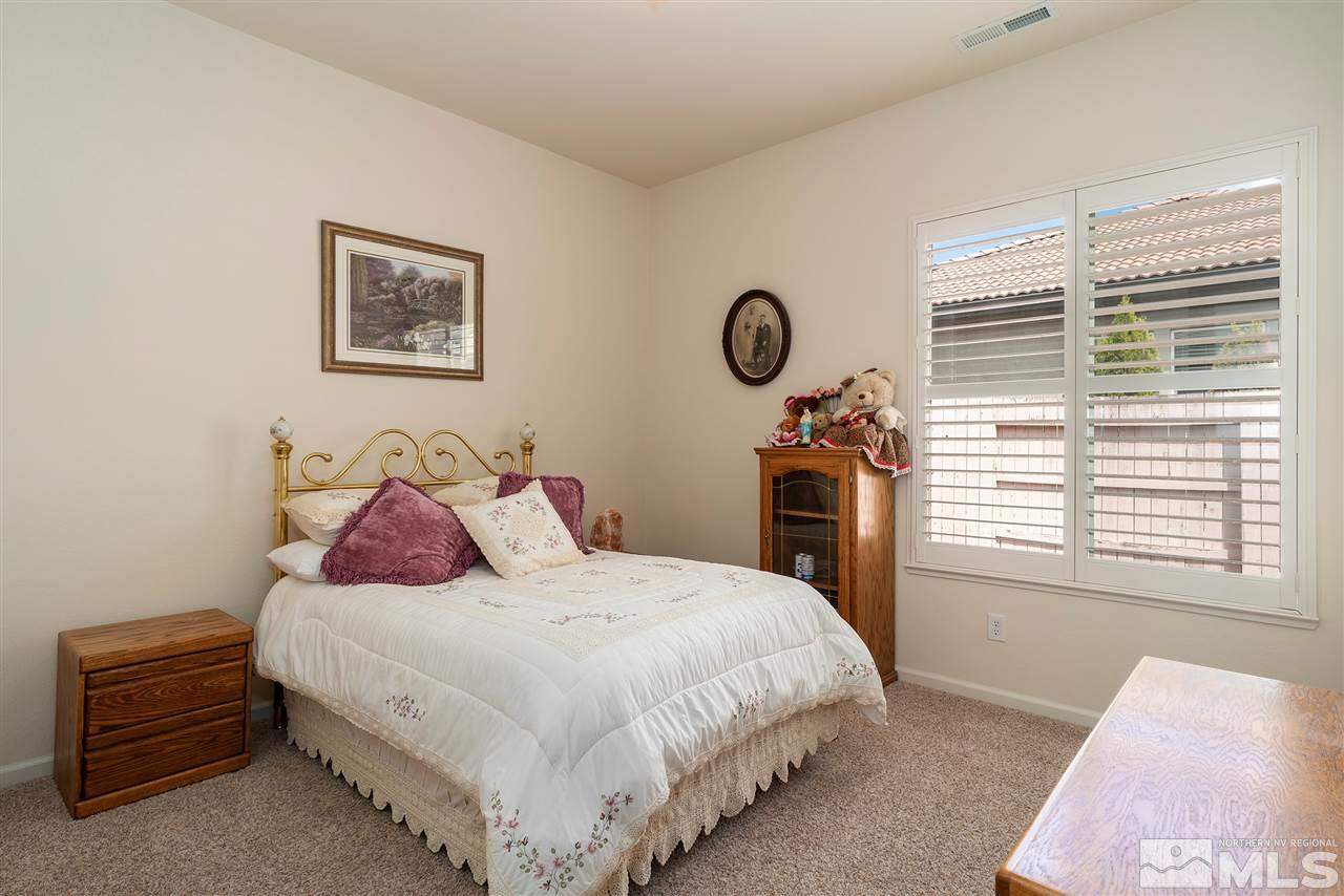2645 Trail Rider Drive Reno, NV 89521 - Photo 9 of 25 a bedroom with a bed a stove and a window