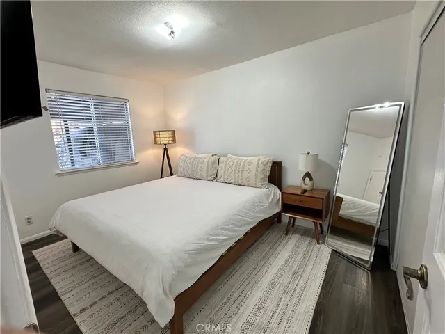 a large bed sitting in a bedroom next to a window