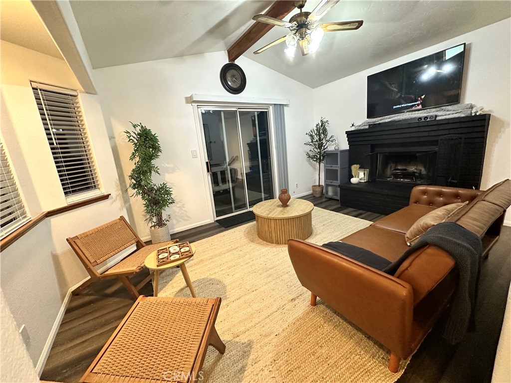 33010 Donner Lane Running Springs, CA 92382 - Photo 20 of 29 a living room with furniture a flat screen tv and a fireplace
