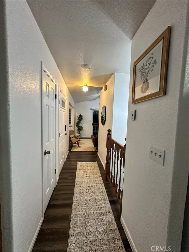 33010 Donner Lane Running Springs, CA 92382 - Photo 22 of 29 a view of a hallway with wooden floor and staircase