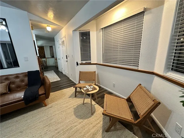 a living room with furniture and two window