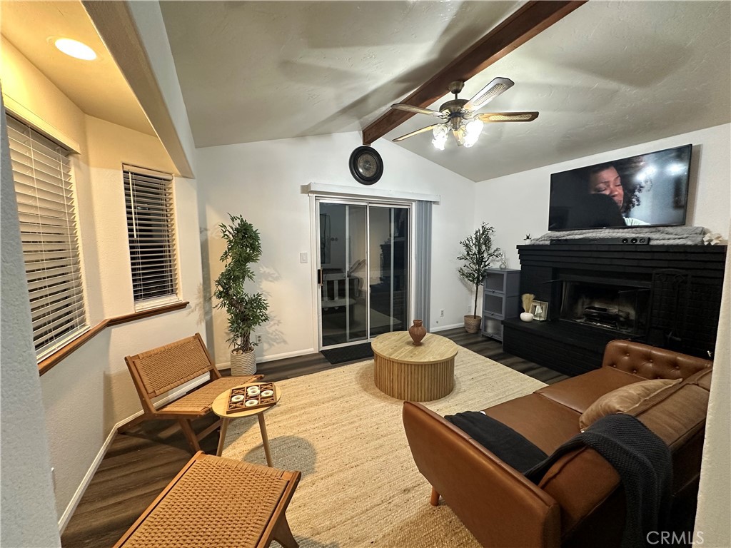 33010 Donner Lane Running Springs, CA 92382 - Photo 27 of 29 a living room with furniture a flat screen tv and a fireplace