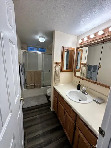 a bathroom with a sink a mirror and shower