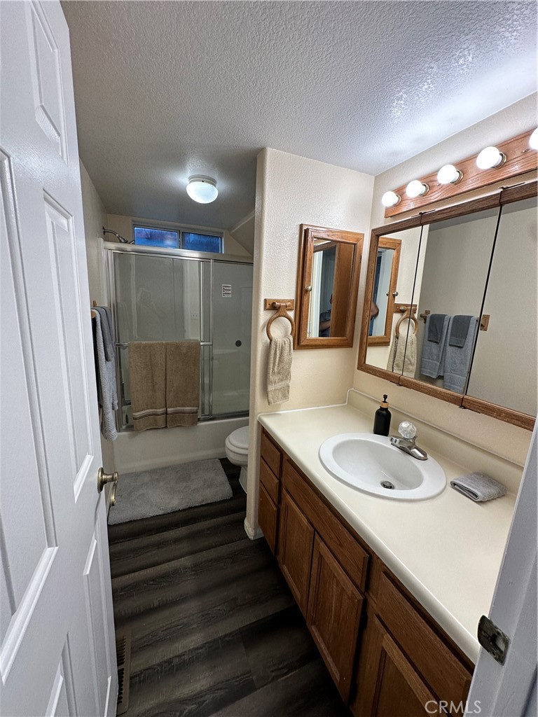 33010 Donner Lane Running Springs, CA 92382 - Photo 9 of 29 a bathroom with a sink a mirror and shower