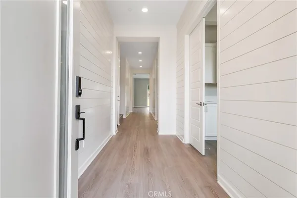 a view of a hallway with wooden floor