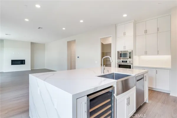 a kitchen that has a sink a stove and chairs