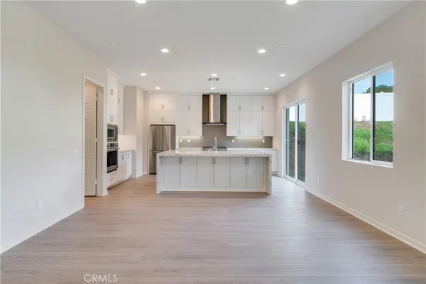 a large white kitchen with a large window