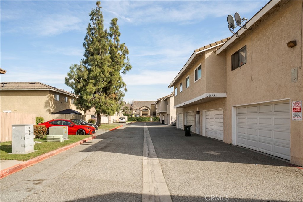 3241 G Ontario, CA 91764 - Photo 6 of 7 a small white building with a bench and a potted plant on it