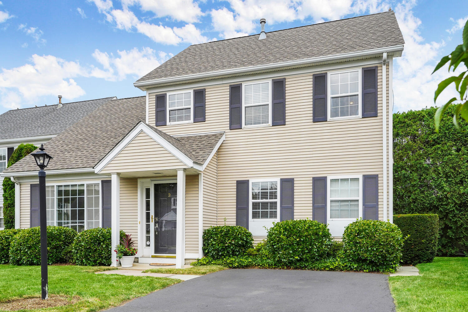 1 Shore Road, Unit 9 Stamford, CT 06902 - Photo 1 of 27 a front view of a house with a yard