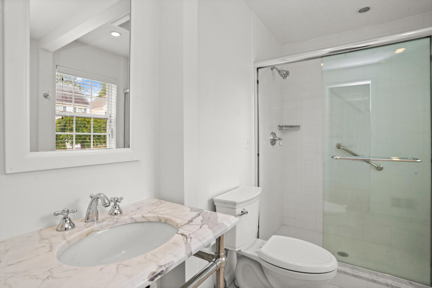 1 Shore Road, Unit 9 Stamford, CT 06902 - Photo 15 of 27 a bathroom with a sink toilet a mirror and shower