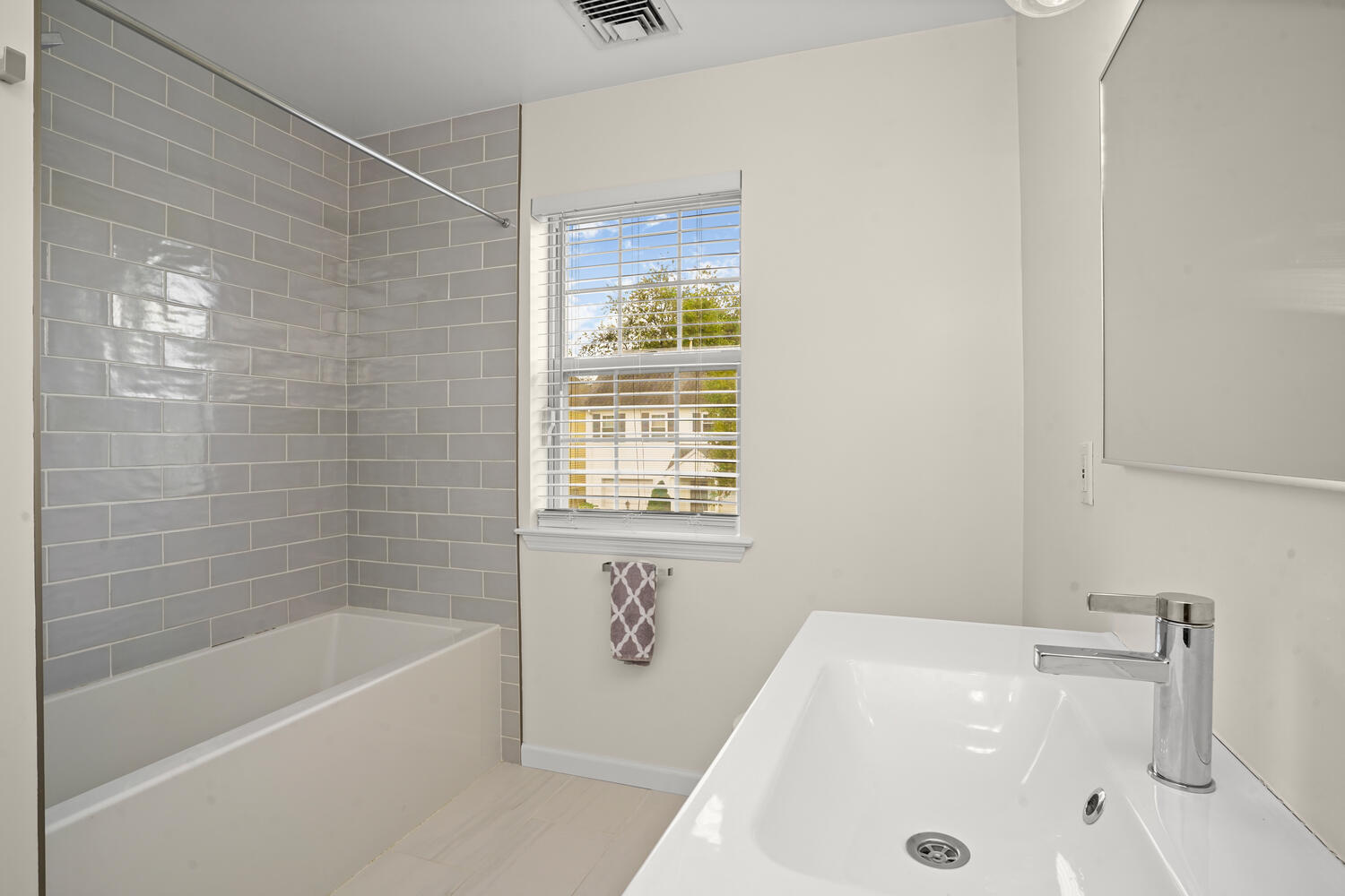 1 Shore Road, Unit 9 Stamford, CT 06902 - Photo 22 of 27 a bathroom with a tub a sink and a window