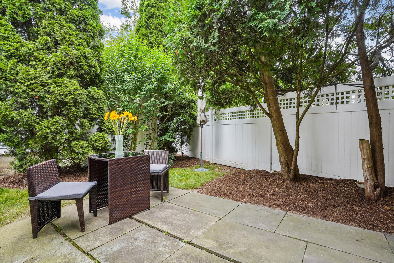 1 Shore Road, Unit 9 Stamford, CT 06902 - Photo 23 of 27 a view of backyard with outdoor seating and trees