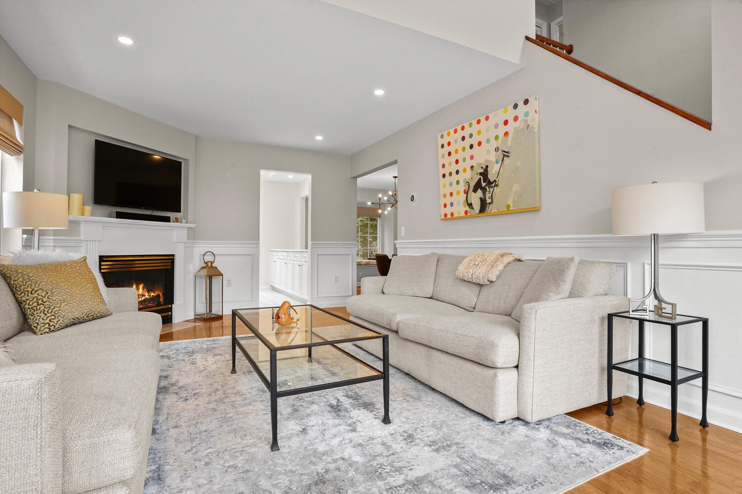 1 Shore Road, Unit 9 Stamford, CT 06902 - Photo 5 of 27 a living room with furniture a fireplace and a flat screen tv