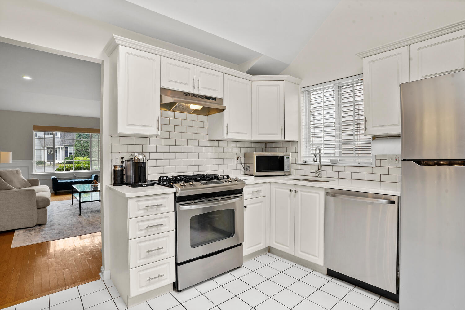 1 Shore Road, Unit 9 Stamford, CT 06902 - Photo 7 of 27 a kitchen with cabinets stainless steel appliances and wooden floor