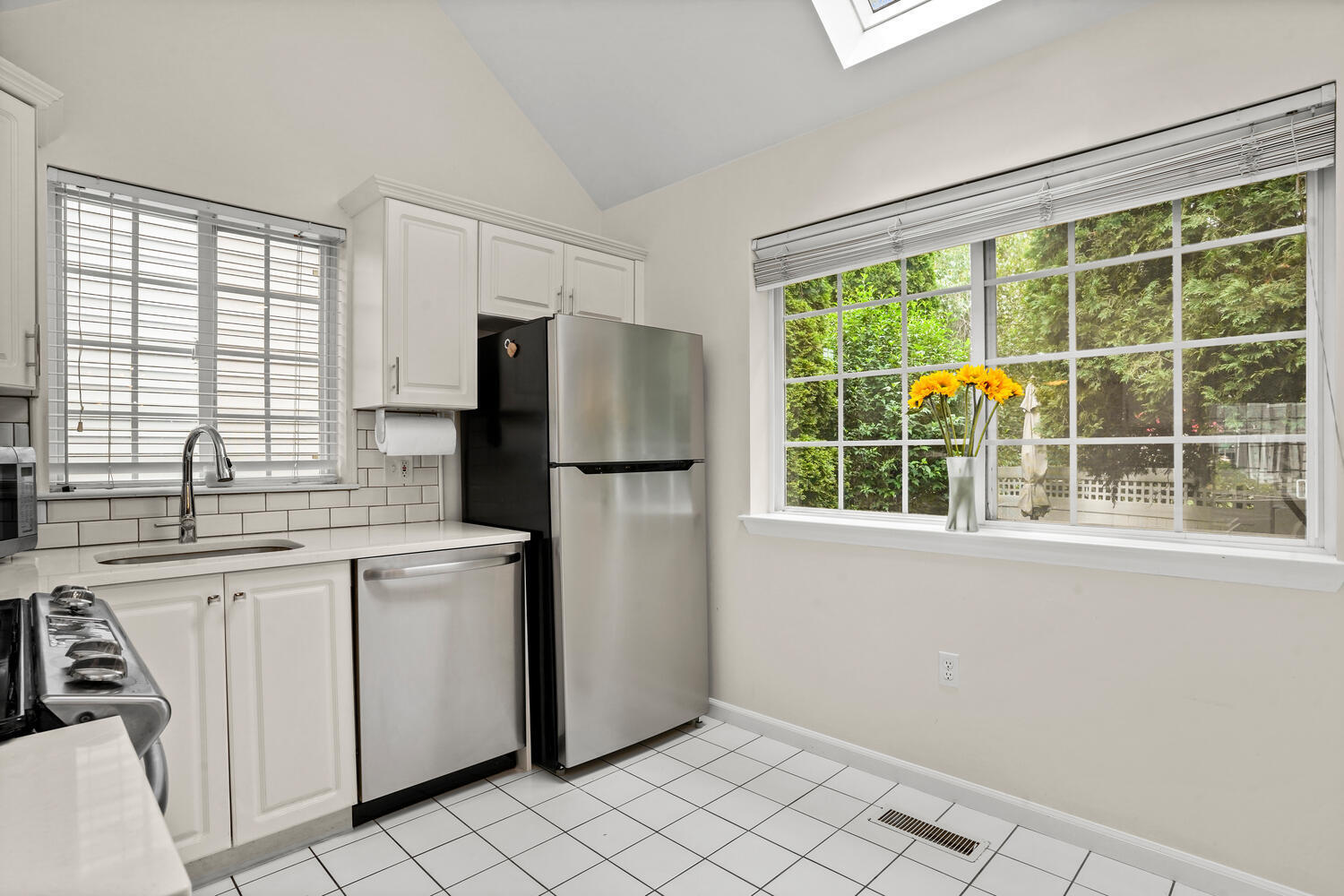 1 Shore Road, Unit 9 Stamford, CT 06902 - Photo 8 of 27 a kitchen with a refrigerator a sink dishwasher and a large window
