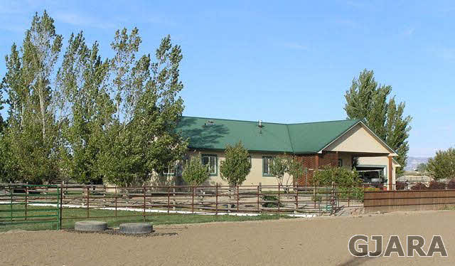 675 S Road Mack, CO 81525 - Photo 1 of 27 a front view of a house with a yard