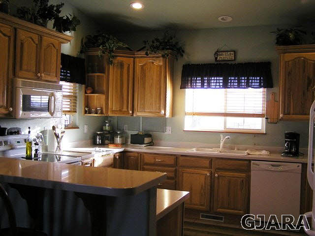 675 S Road Mack, CO 81525 - Photo 16 of 27 a kitchen with granite countertop a sink a window stainless steel appliances and cabinets