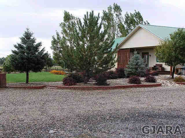 675 S Road Mack, CO 81525 - Photo 19 of 27 a front view of a house with a yard and garage