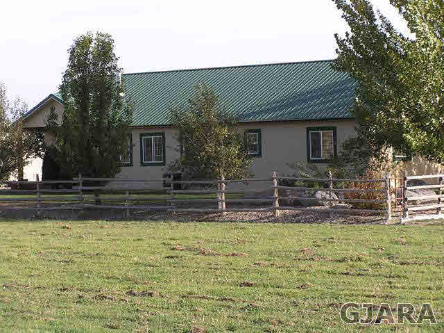 675 S Road Mack, CO 81525 - Photo 2 of 27 a house with trees in the background