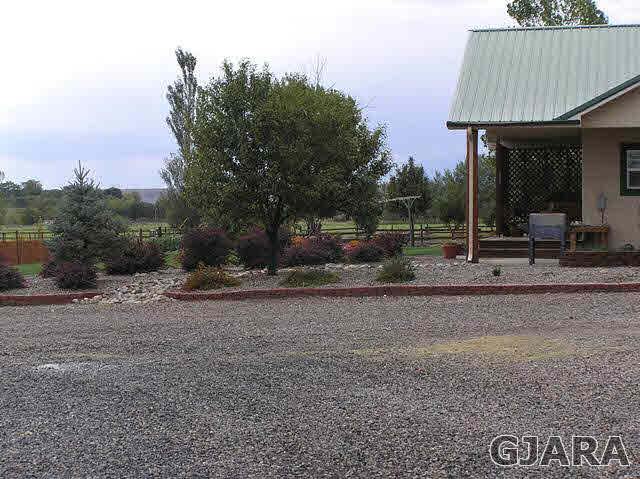 675 S Road Mack, CO 81525 - Photo 25 of 27 a backyard of a house with table and chairs
