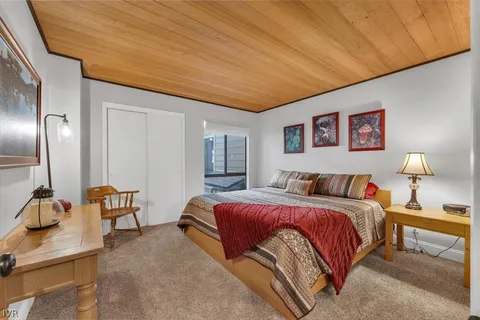 a bedroom with a bed and a lamp on table