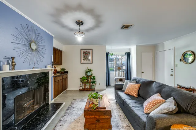 a living room with furniture and a fireplace
