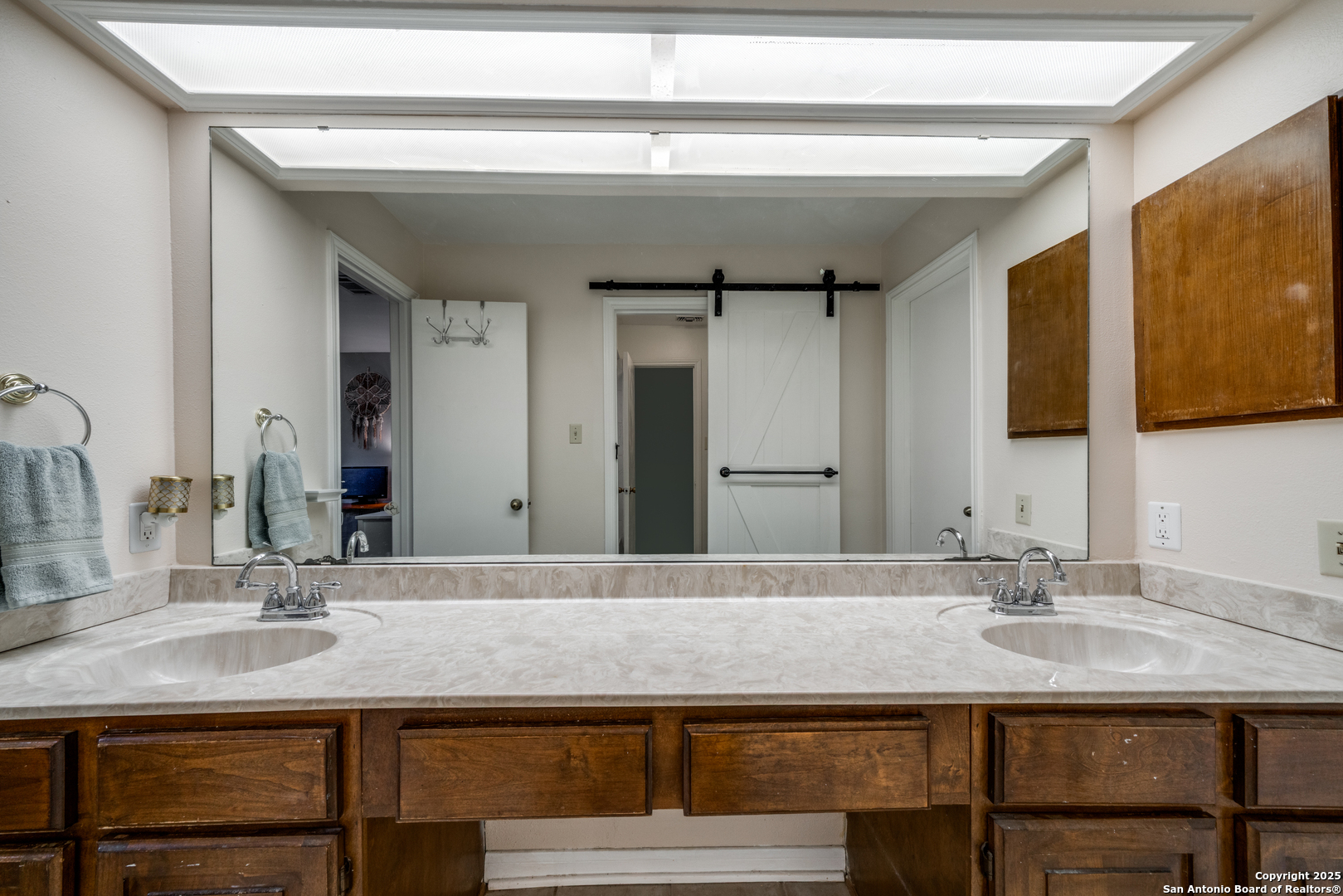 7738 Chambers Road, Unit 903 San Antonio, TX 78229 - Photo 14 of 22 a bathroom with a sink and a mirror