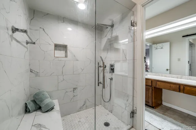 a bathroom with a shower and a sink