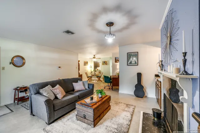 a living room with furniture a rug and a large window