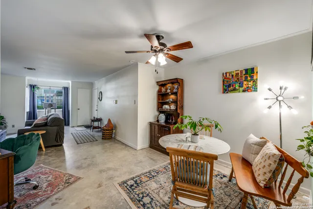 a living room with furniture a rug and a chandelier