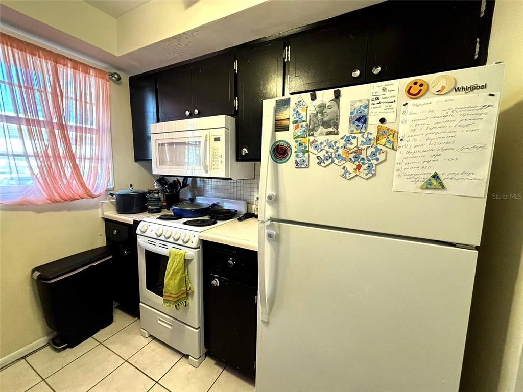 1433 South Belcher Road, Unit B2 Clearwater, FL 33764 - Photo 5 of 20 a white refrigerator freezer sitting inside of a kitchen
