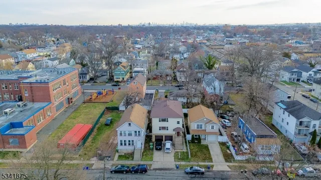 an aerial view of multiple houses with yard