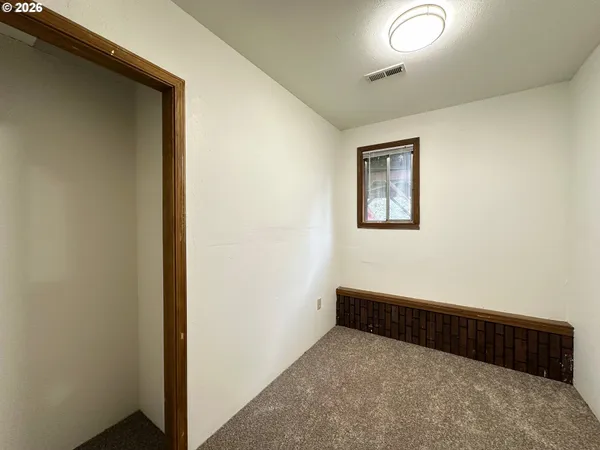 a view of hallway with window and a dresser
